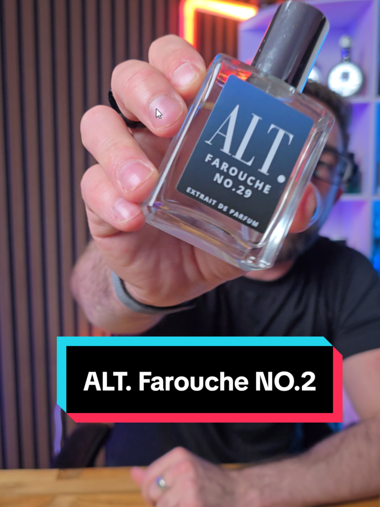 Loren Noble holding an ALT. Farouche No. 29 fragrance bottle close to the camera