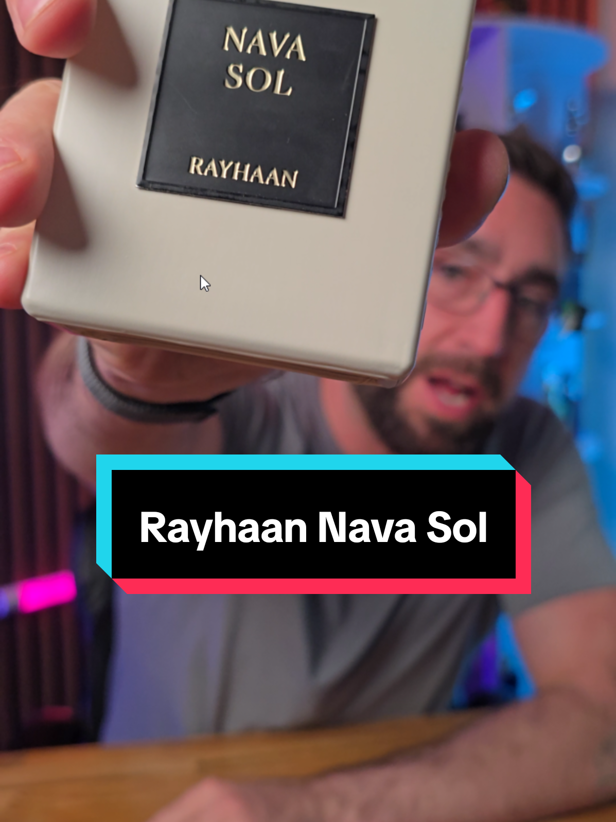 Loren Noble presenting a Rayhaan Nava Sol fragrance bottle
