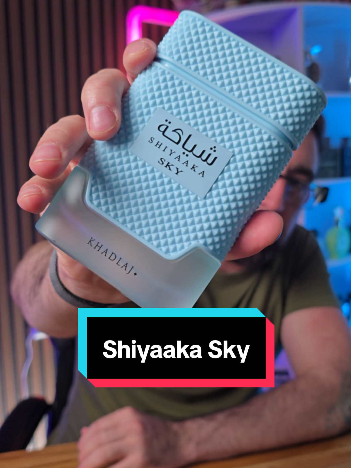 Loren Noble holding a pale blue Khadlaj Shiyaaka Sky fragrance bottle