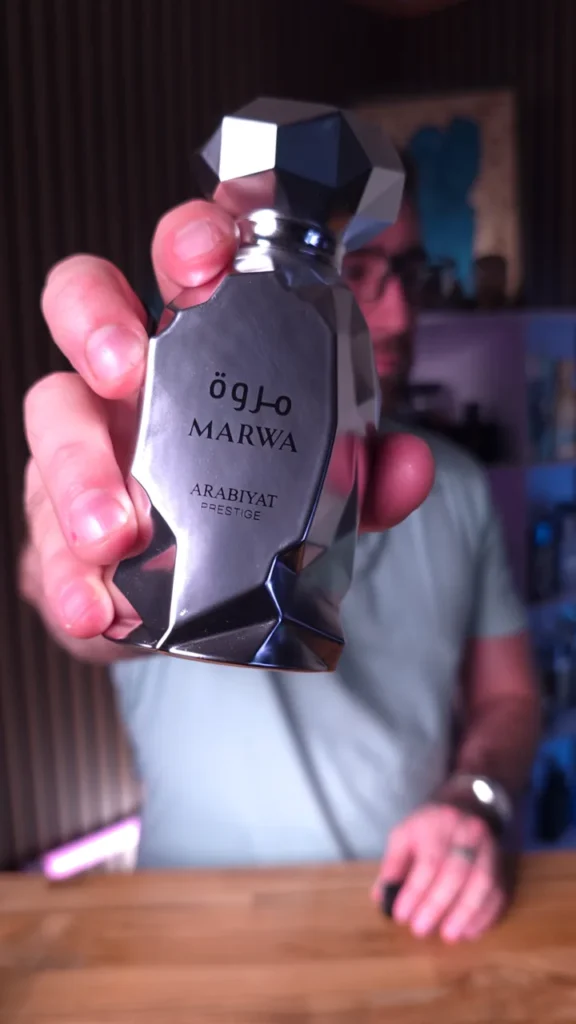 Close-up product demonstration of an Arabiyat Prestige fragrance